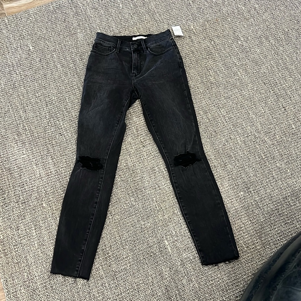 Never worn, black jean high rise Jegging.  Size 23 waist
